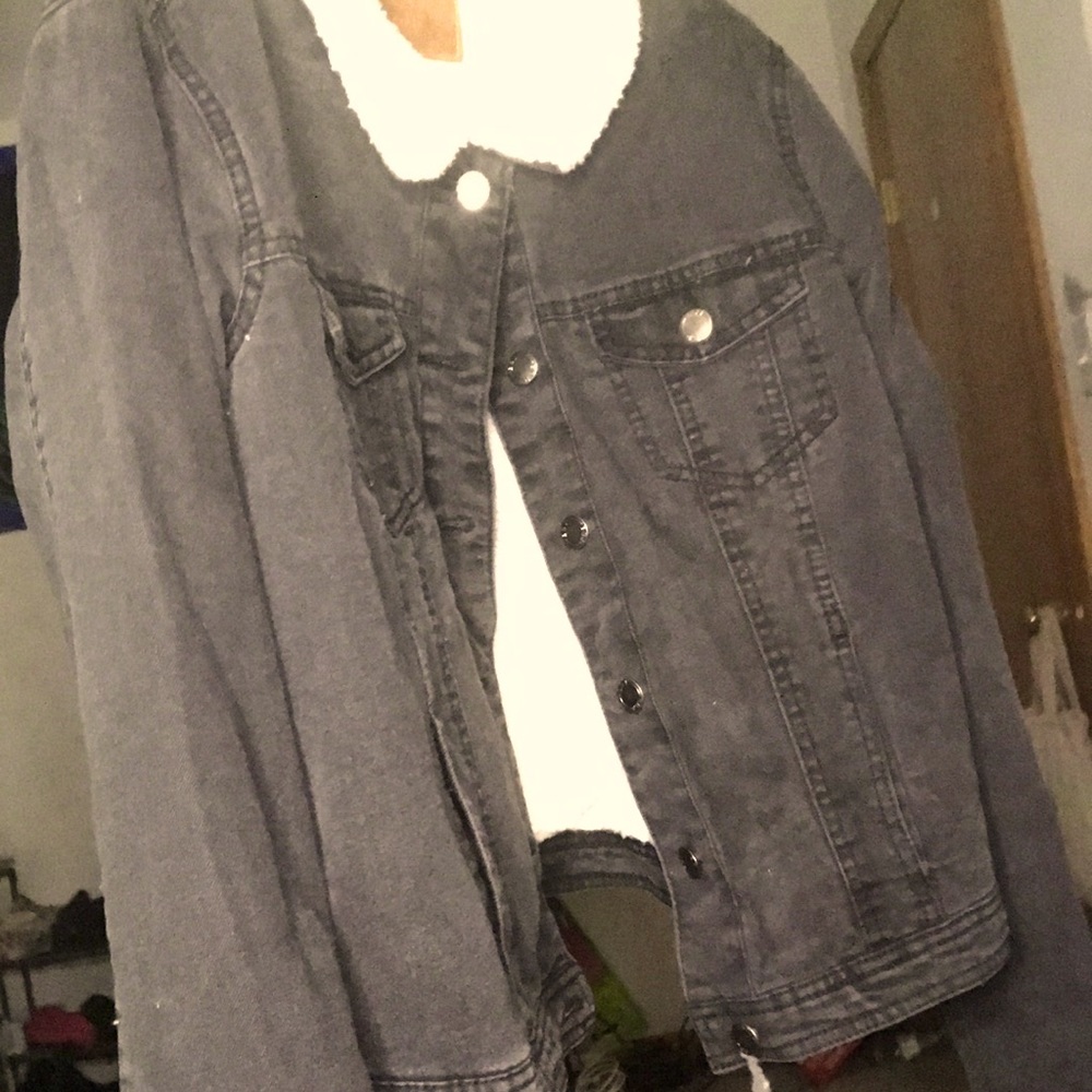 It is a warm blackish grey jean jacket with white fur